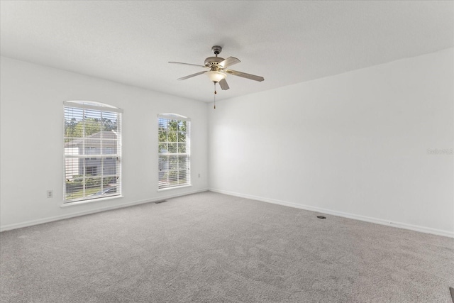 2741 Merrieweather Ln, Kissimmee, FL 34743 - unfurnished room featuring carpet flooring, a ceiling fan, baseboards, and visible vents