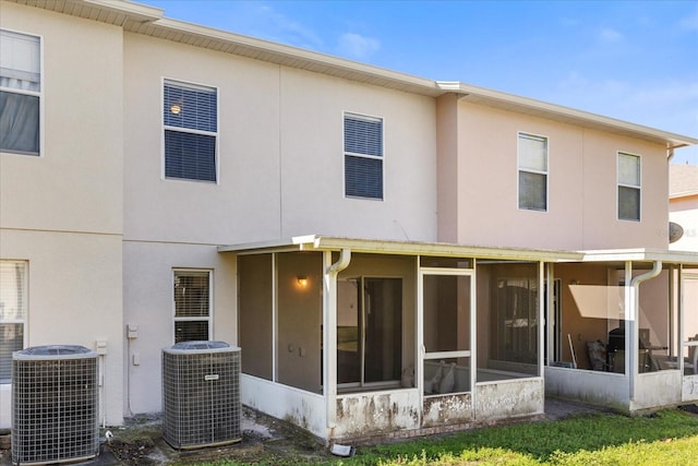 2741 Merrieweather Ln, Kissimmee, FL 34743 - rear view of house with stucco siding and central air condition unit