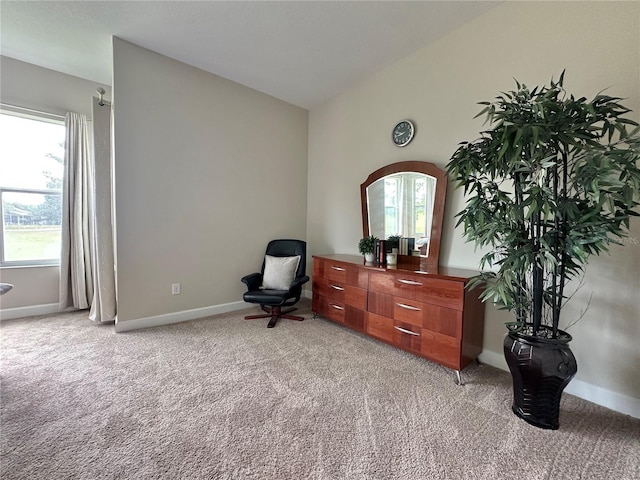 living area with lofted ceiling, baseboards, light carpet, and plenty of natural light