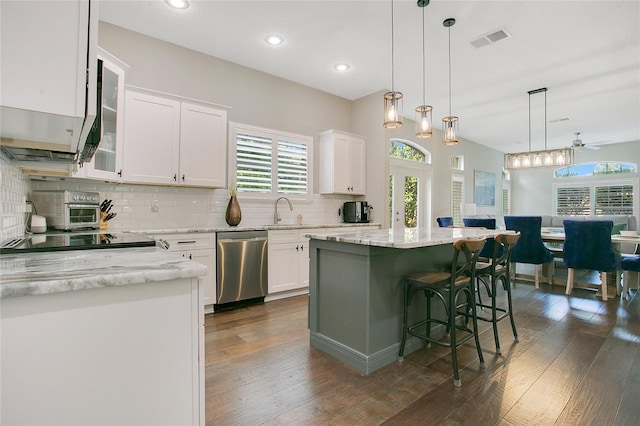 7003 Somerton Blvd, Orlando, FL 32819 - kitchen with visible vents, decorative backsplash, white cabinetry, and dishwasher