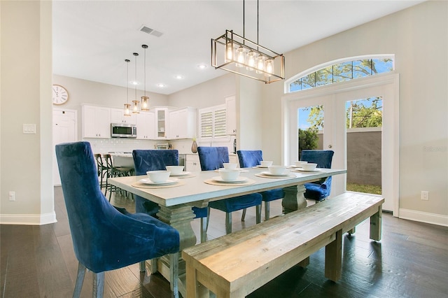 7003 Somerton Blvd, Orlando, FL 32819 - dining room with a chandelier, french doors, baseboards, and dark wood-style floors