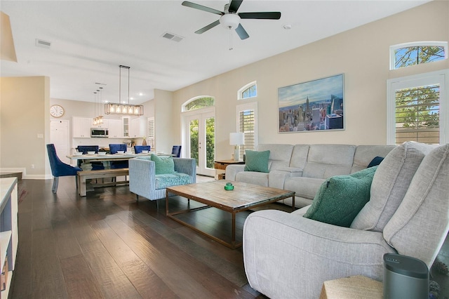 7003 Somerton Blvd, Orlando, FL 32819 - living area featuring dark wood-style flooring, visible vents, baseboards, and ceiling fan with notable chandelier