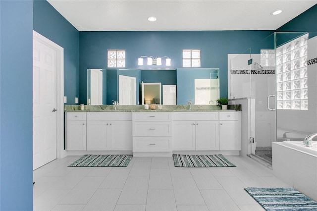 7003 Somerton Blvd, Orlando, FL 32819 - bathroom with a sink, double vanity, a stall shower, tile patterned flooring, and a garden tub