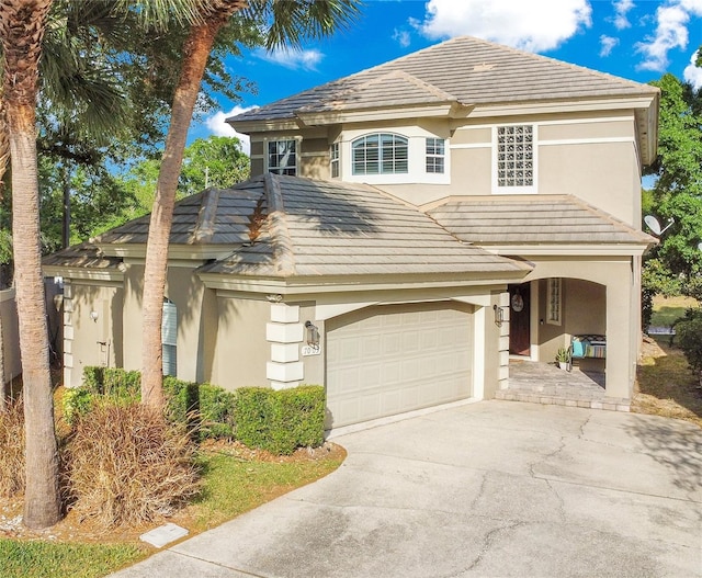 7003 Somerton Blvd, Orlando, FL 32819 - view of front of house featuring concrete driveway, a tiled roof, and stucco siding