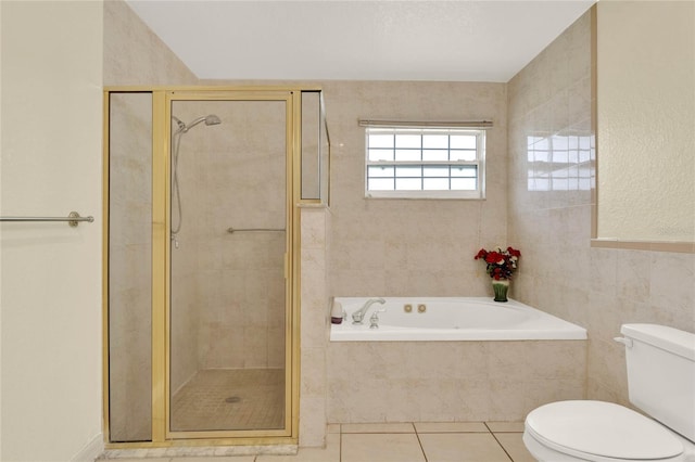 full bathroom featuring a stall shower, toilet, tile patterned flooring, and tile walls