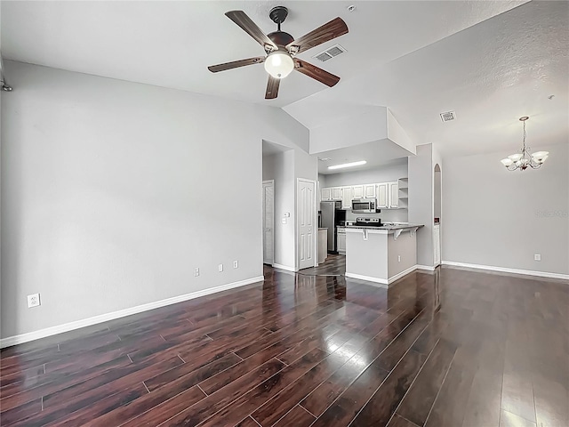 unfurnished living room with baseboards, vaulted ceiling, ceiling fan with notable chandelier, dark wood-style floors, and visible vents