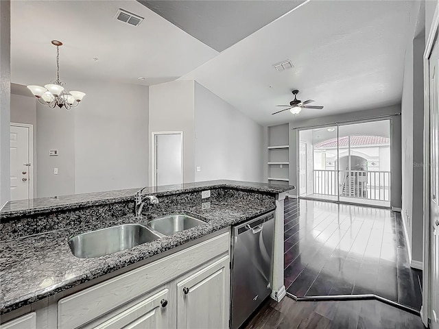 kitchen featuring dark stone counters, visible vents, dishwasher, and a sink