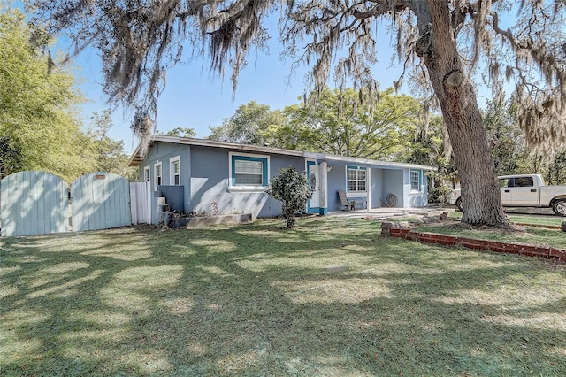 243 W Martin St, Apopka, FL 32712 - single story home with a gate, stucco siding, and a front yard