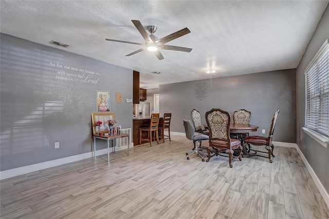 243 W Martin St, Apopka, FL 32712 - dining area featuring a ceiling fan, light wood-style floors, and a textured ceiling