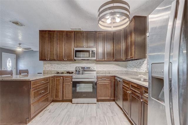 243 W Martin St, Apopka, FL 32712 - kitchen with tasteful backsplash, a peninsula, visible vents, ceiling fan, and appliances with stainless steel finishes