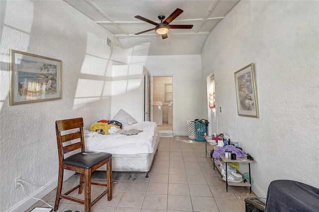 243 W Martin St, Apopka, FL 32712 - bedroom with visible vents, a ceiling fan, a textured wall, independent washer and dryer, and light tile patterned flooring