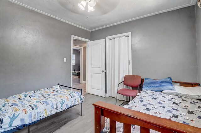 243 W Martin St, Apopka, FL 32712 - bedroom with crown molding, wood finished floors, a closet, and a ceiling fan