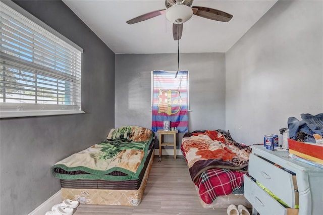 243 W Martin St, Apopka, FL 32712 - bedroom with baseboards, a ceiling fan, and wood finished floors