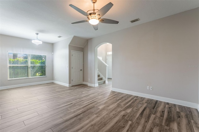 1197 Tallow Rd, Apopka, FL 32703 - unfurnished room with wood finished floors, baseboards, stairs, and ceiling fan