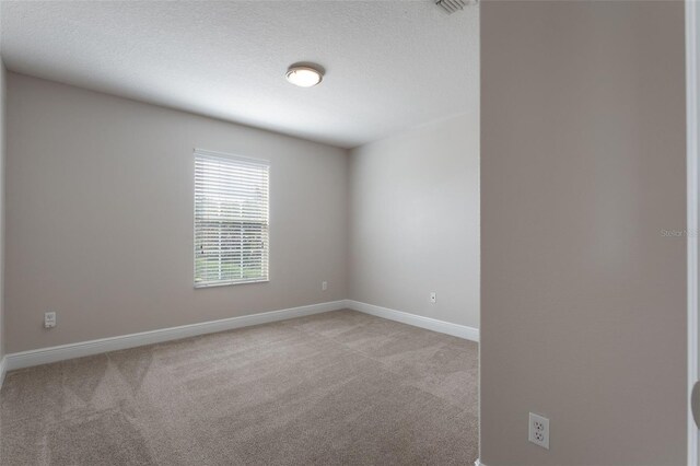1197 Tallow Rd, Apopka, FL 32703 - unfurnished room with light carpet, baseboards, and a textured ceiling