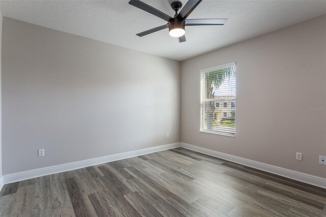 1197 Tallow Rd, Apopka, FL 32703 - unfurnished room featuring dark wood-type flooring, ceiling fan, baseboards, and a textured ceiling