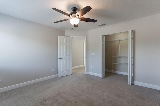 1197 Tallow Rd, Apopka, FL 32703 - unfurnished bedroom featuring a closet, light carpet, ceiling fan, a textured ceiling, and baseboards
