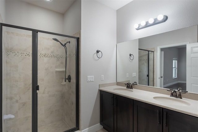 1197 Tallow Rd, Apopka, FL 32703 - bathroom featuring a shower stall, double vanity, and baseboards