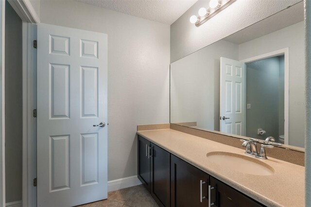 1197 Tallow Rd, Apopka, FL 32703 - bathroom with vanity, toilet, tile patterned flooring, and baseboards