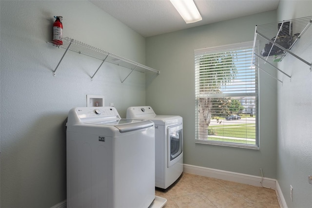 1197 Tallow Rd, Apopka, FL 32703 - laundry room with separate washer and dryer, light tile patterned floors, and baseboards