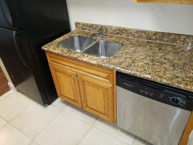 4779 S Texas Ave Unit 4779C, Orlando, FL 32839 - kitchen featuring light tile patterned flooring, dishwasher, a sink, brown cabinetry, and freestanding refrigerator