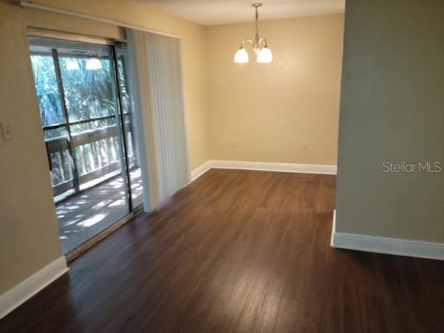 4779 S Texas Ave Unit 4779C, Orlando, FL 32839 - unfurnished room with baseboards, wood finished floors, and a chandelier
