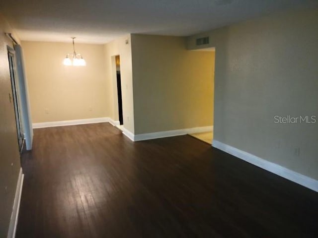 4779 S Texas Ave Unit 4779C, Orlando, FL 32839 - empty room with baseboards, visible vents, and a chandelier