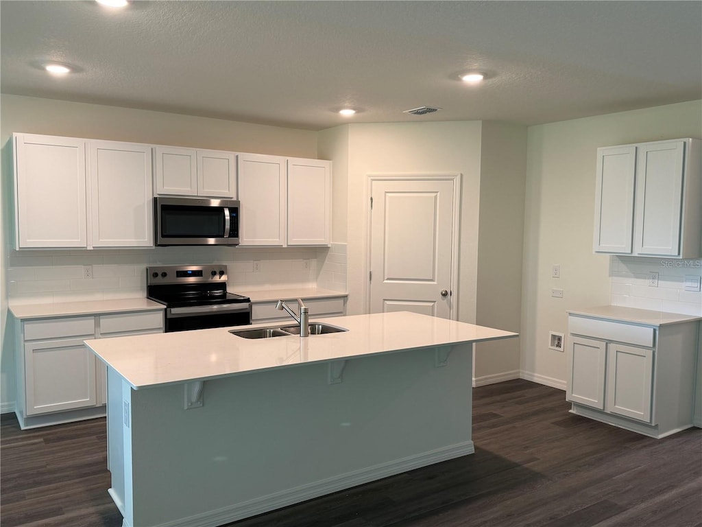 4245 Acoma Dr, Ormond Beach, FL 32174 - kitchen featuring stainless steel microwave, electric stove, tasteful backsplash, dark wood-style floors, and light countertops