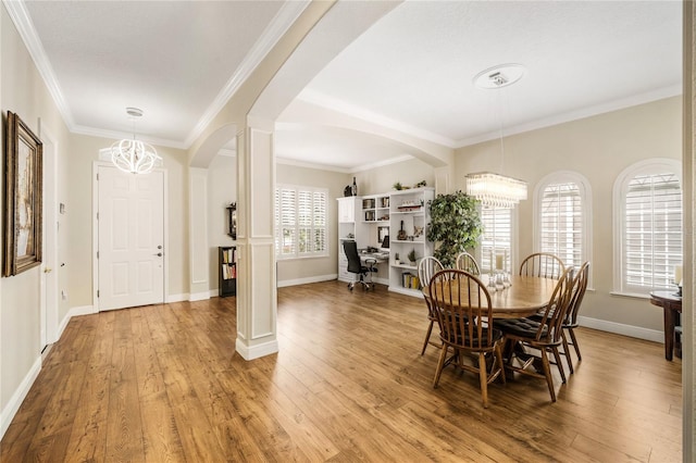 1638 Swallowtail Ln, Sanford, FL 32771 - dining room featuring an inviting chandelier, ornamental molding, arched walkways, and light wood-style floors
