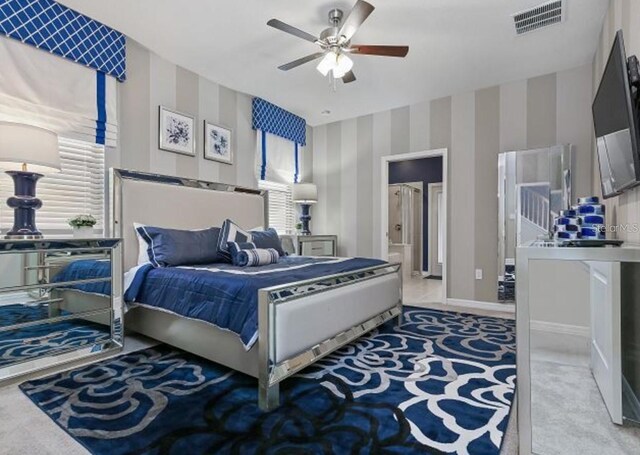 8892 Bengal Ct, Kissimmee, FL 34747 - bedroom featuring wallpapered walls, carpet floors, baseboards, a ceiling fan, and connected bathroom