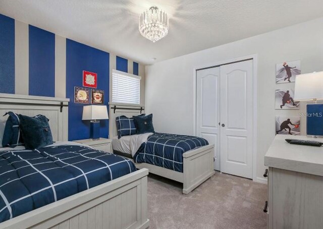 8892 Bengal Ct, Kissimmee, FL 34747 - bedroom featuring light colored carpet, a closet, and a chandelier