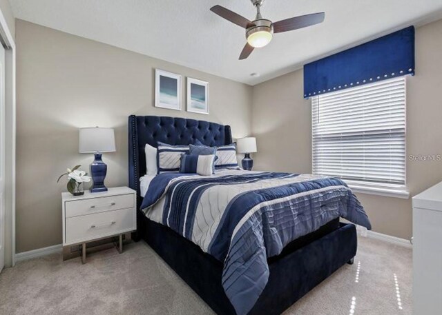 8892 Bengal Ct, Kissimmee, FL 34747 - bedroom with light colored carpet, baseboards, and ceiling fan