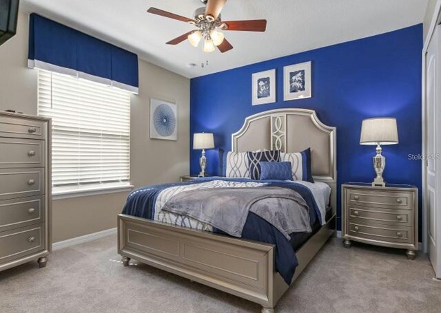 8892 Bengal Ct, Kissimmee, FL 34747 - carpeted bedroom with baseboards and ceiling fan