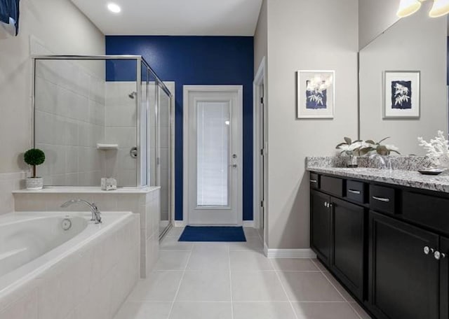 8892 Bengal Ct, Kissimmee, FL 34747 - bathroom with vanity, a bath, a stall shower, and tile patterned flooring