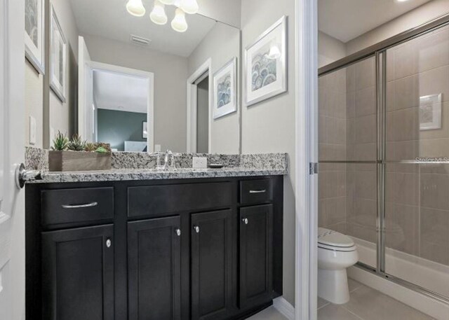 8892 Bengal Ct, Kissimmee, FL 34747 - full bath with vanity, a stall shower, toilet, and tile patterned floors