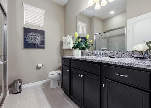 8892 Bengal Ct, Kissimmee, FL 34747 - bathroom with vanity, toilet, a shower stall, baseboards, and tile patterned floors