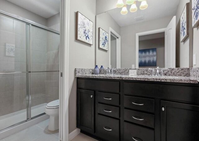 8892 Bengal Ct, Kissimmee, FL 34747 - full bathroom featuring toilet, double vanity, a shower stall, and tile patterned flooring
