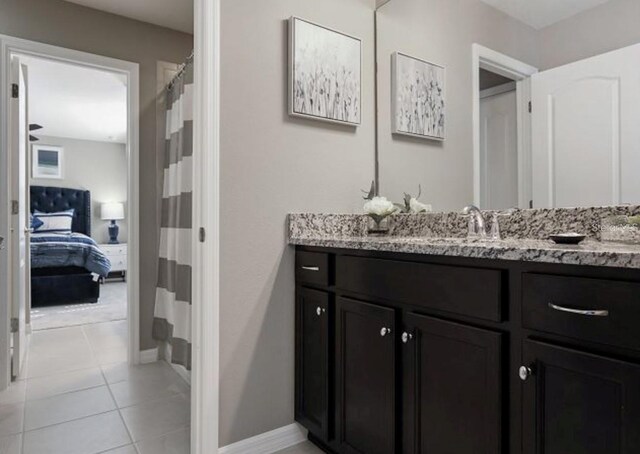 8892 Bengal Ct, Kissimmee, FL 34747 - ensuite bathroom featuring vanity, tile patterned flooring, curtained shower, and baseboards