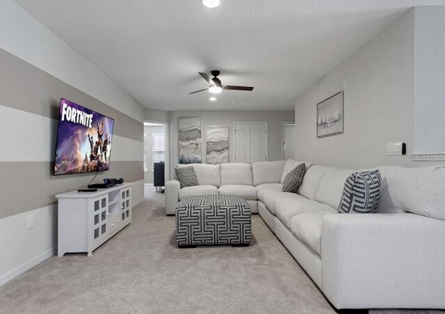 8892 Bengal Ct, Kissimmee, FL 34747 - living room with ceiling fan, light carpet, and baseboards
