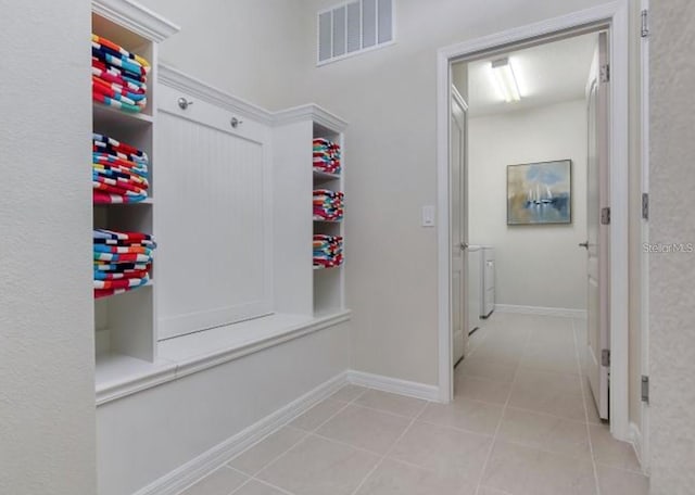 8892 Bengal Ct, Kissimmee, FL 34747 - mudroom with tile patterned floors, washing machine and dryer, and baseboards