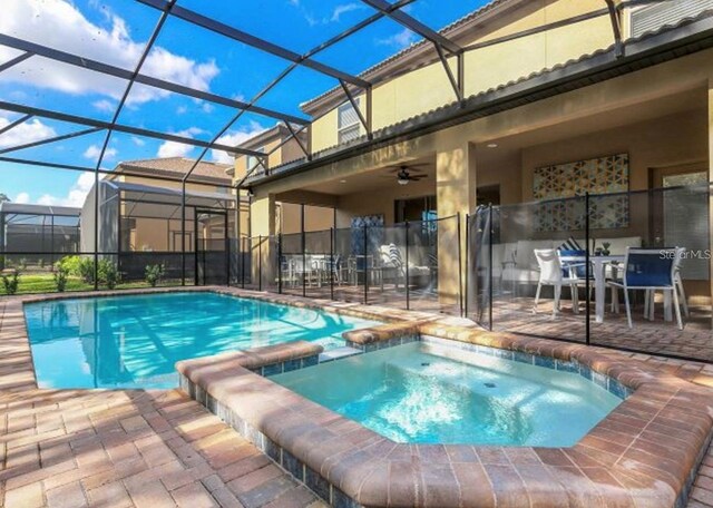 8892 Bengal Ct, Kissimmee, FL 34747 - view of swimming pool with a patio area, a pool with connected hot tub, a lanai, and a ceiling fan