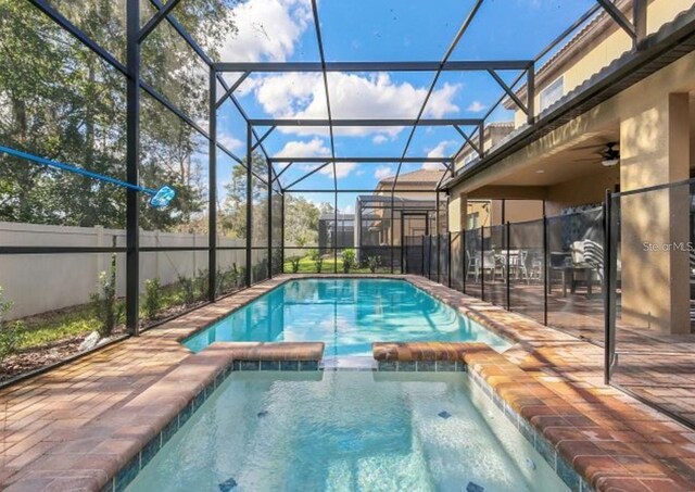 8892 Bengal Ct, Kissimmee, FL 34747 - view of swimming pool with a pool with connected hot tub, a lanai, and a patio