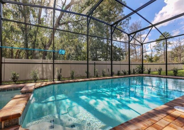 8892 Bengal Ct, Kissimmee, FL 34747 - swimming pool featuring glass enclosure