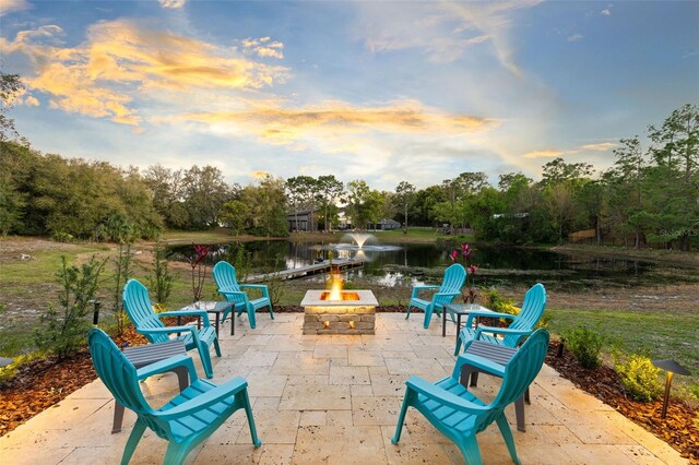 835 Dyson Dr, Winter Springs, FL 32708 - patio terrace at dusk with a water view, a patio area, a fire pit, and view of scattered trees