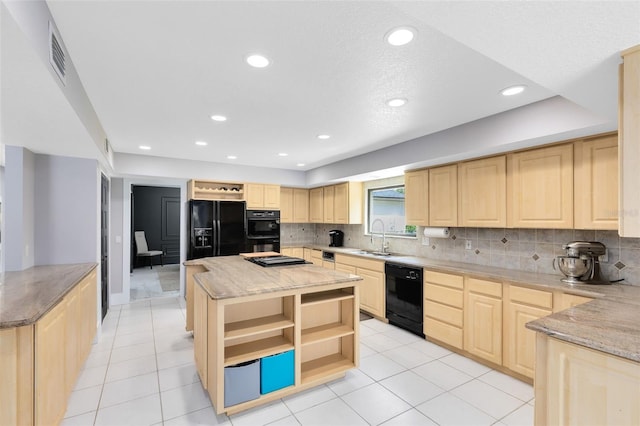 835 Dyson Dr, Winter Springs, FL 32708 - kitchen with light brown cabinetry, black appliances, open shelves, a center island, and light stone counters