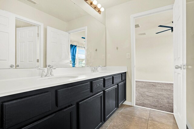 2200 Rapollo Dr, Kissimmee, FL 34741 - full bath featuring double vanity, a sink, tile patterned flooring, and baseboards