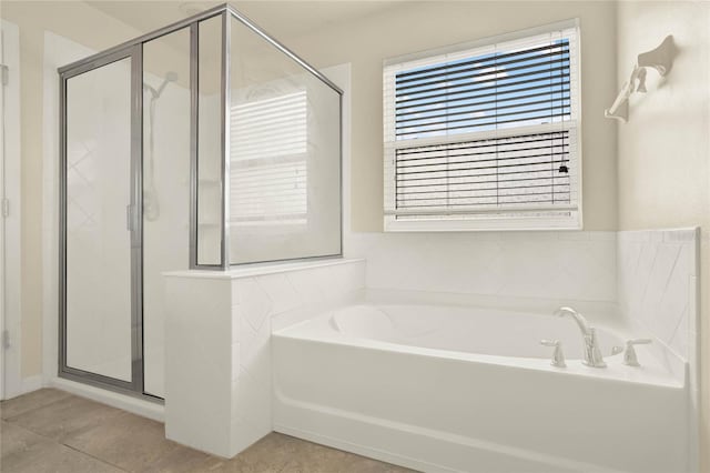 2200 Rapollo Dr, Kissimmee, FL 34741 - full bathroom featuring a shower stall, tile patterned flooring, and a bath