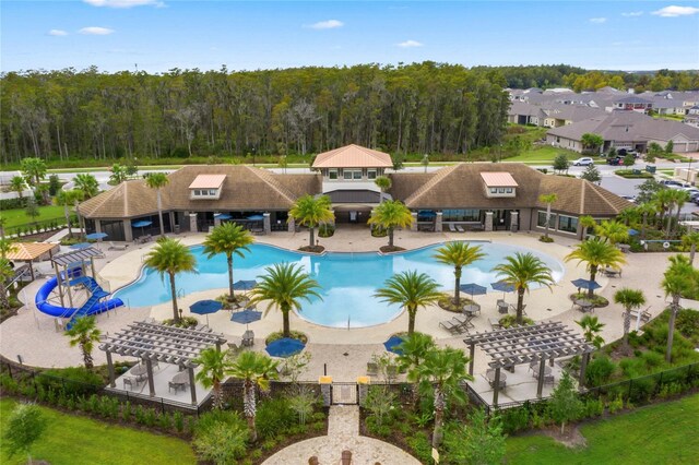 2200 Rapollo Dr, Kissimmee, FL 34741 - community pool featuring a pergola, a view of trees, fence, and a patio