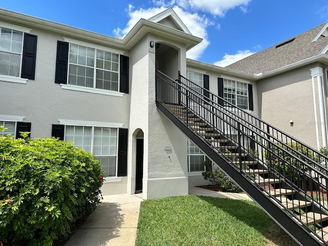 9021 Lee Vista Blvd Unit 1707, Orlando, FL 32829 - view of exterior entry with central air condition unit and stucco siding