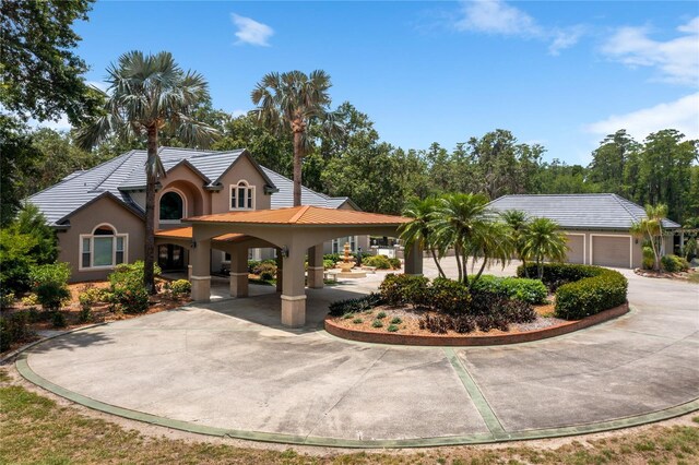 11450 Nellie Oaks Bnd, Clermont, FL 34711 - view of front of house featuring stucco siding, curved driveway, and a tiled roof